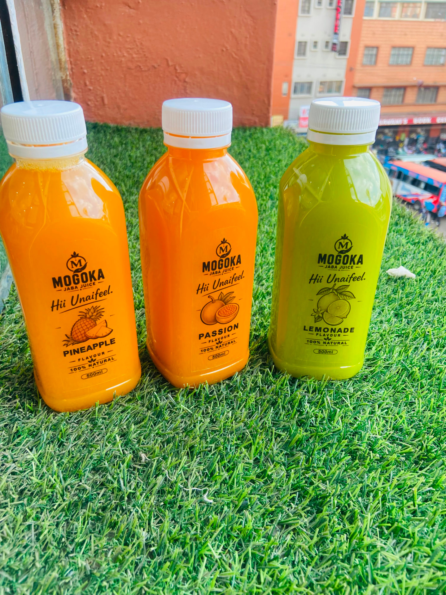 Pineapple, Passion and Lemonade Mogoka bottles on a Nairobi rooftop